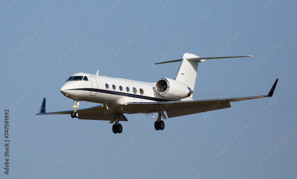 Obraz premium Light private jet comes in for a landing. High quality photo