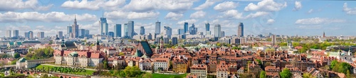 Warsaw old town and distant city center, PKiN and skyline under blue cloudy sky aerial landscape © lukszczepanski
