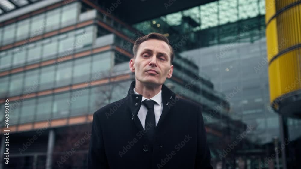 Businessman posing in front of glas office building Businessman posing in front of glas office building