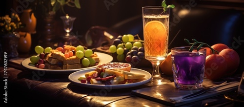 A table in a restaurant is set with plates of appetizers and glasses of juice. The spread is inviting and ready to be enjoyed by diners in the establishment.