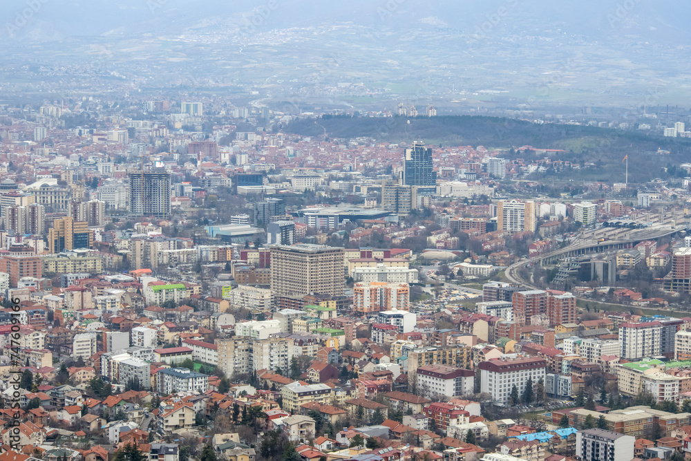 European mountain city seen from above at sunset on a cloudy day, Skopje the capital city.