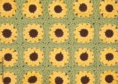 Close up on finished connected crochet sunflower granny squares showing blanket.