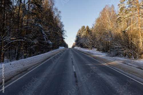 a slippery and dangerous road covered with snow and ice © rsooll