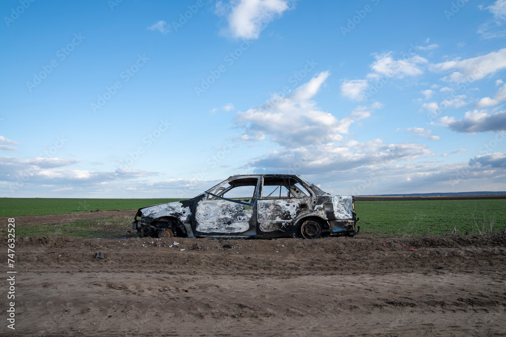 A burned out car. Burnt car in the field. Car fire, vehicle fire due to short circuit. Stolen car intentional arson. One vehicle was damaged in the fire.