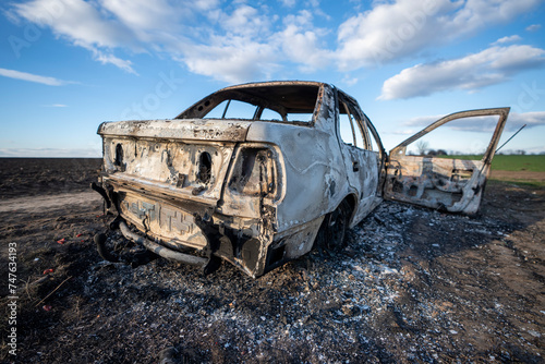 A burned out car. Burnt car in the field. Car fire, vehicle fire due to short circuit. Stolen car intentional arson. One vehicle was damaged in the fire.