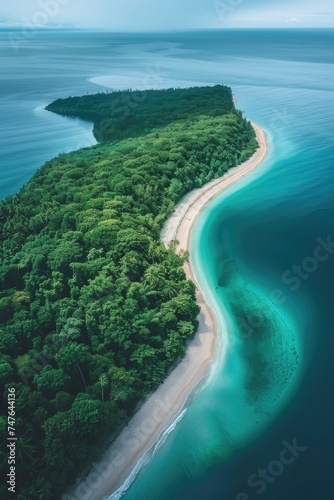 Overhead Capture: Lush Vegetation and Sandy Beach Curve Around a Turquoise Lagoon on a Crescent Island