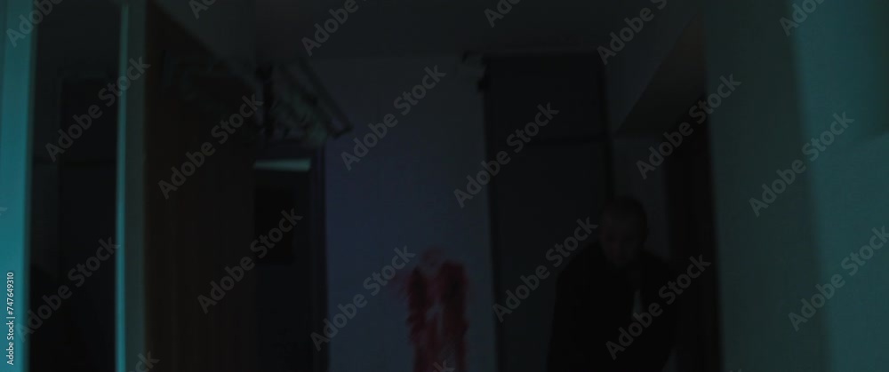 A bald man kicks out the door and enters a flat A bald man kicks out the door and enters a flat
