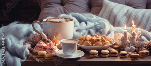 A table in a cozy living room is adorned with an assortment of cookies and a steaming cup of coffee. The cookies are neatly arranged,