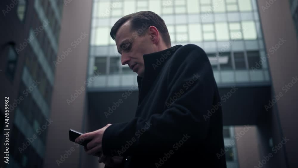 Business man on phone calling texting in front of building Business man on phone calling texting in front of building