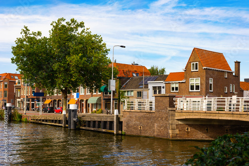 Neat residential buildings along canal of Delft embankment, Netherlands.