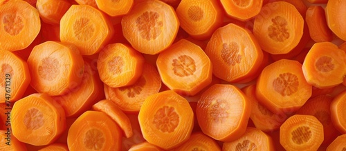 A top-down view of a pile of raw and sliced carrots, a healthy and vitamin-rich background.