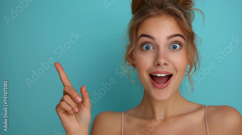 A lively girl points to a vibrant banner for expressive ads. Her enthusiasm and smile create an energetic backdrop. The copy space on the banner invites impactful promotions.