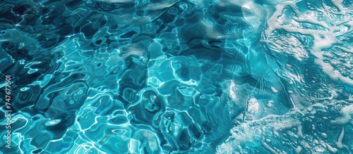 The photo showcases a stunning pool with a captivating blend of transparent blue water and white bubbles creating a mesmerizing texture pattern.