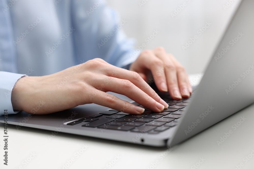 E-learning. Woman using laptop at white table indoors, closeup E-learning. Woman using laptop at white table indoors, closeup