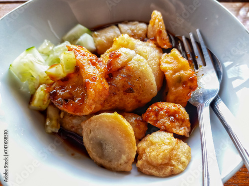 Pempek or Empek-empek is popular savory fishcake from Palembang, South Sumatra, Indonesia. Served on white plate. photo