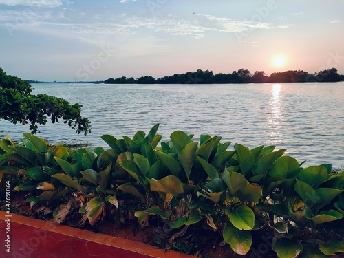 Teluk Intan's charming Riverside, adorned with a scenic waterfront, invites serenity at sunset—a haven for recreation amid a breathtaking landscape. photo