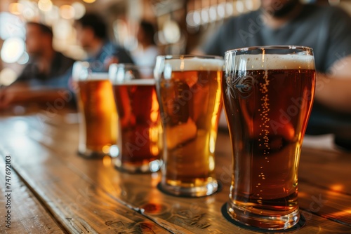 Group of people drinking beer at brewery pub restaurant - Happy friends enjoying happy hour sitting at bar table - Closeup image of brew glasses - Food and beverage lifestyle concept 