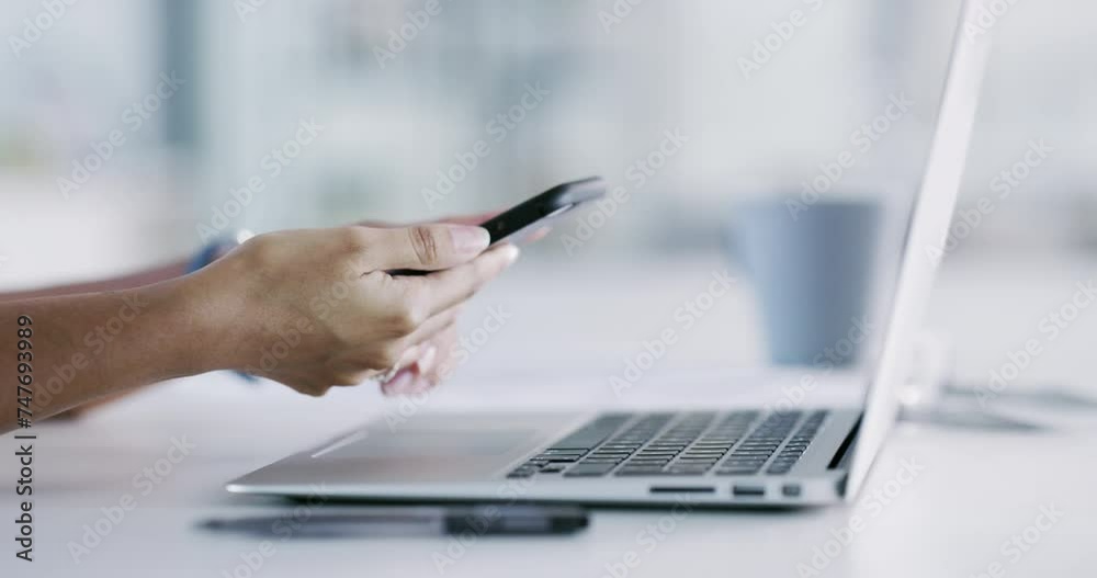 Smartphone, communication and hands with typing on laptop, desk and message online on project at work. Person, entrepreneur and writing on keyboard on pc, technology and internet on cellphone on text Smartphone, communication and hands with typing on laptop, desk and message online on project at work. Person, entrepreneur and writing on keyboard on pc, technology and internet on cellphone on text