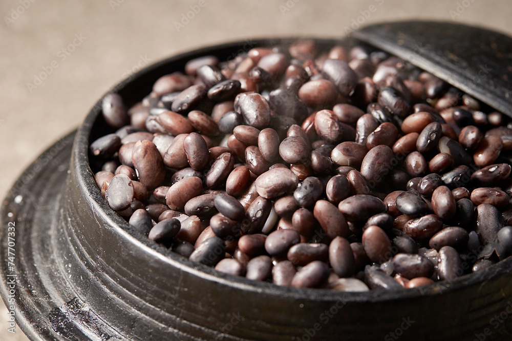 Fototapeta premium Black bean rice in a cauldron