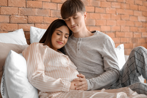 Happy pregnant couple relax...
