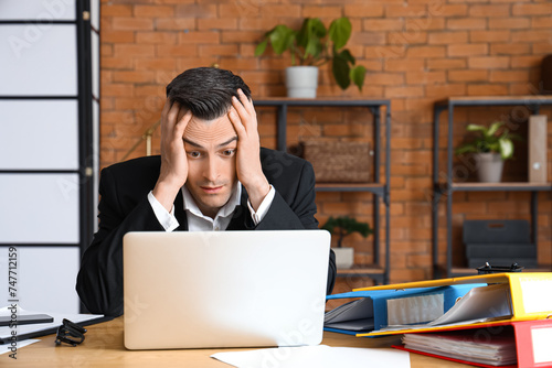 Stressed businessman workin...