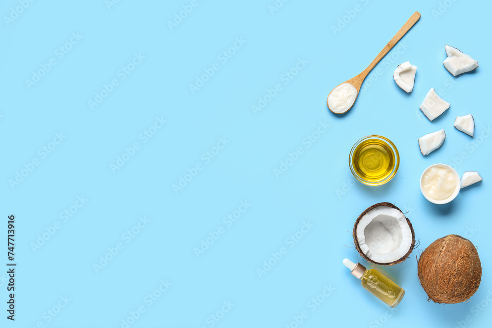 Bottle and bowls of coconut cosmetic oil on blue background Bottle and bowls of coconut cosmetic oil on blue background