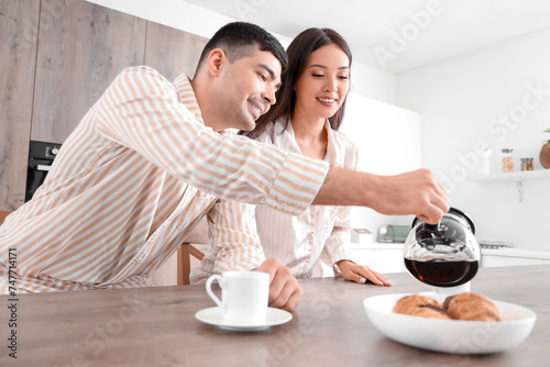 Happy young couple having b...