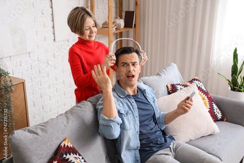 Annoyed man reacting to dau...
