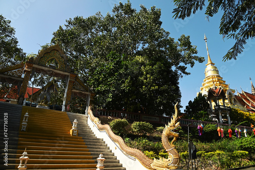 The large golden pagoda, which contains the sacred hair and relics of the Lord Buddha, is approximately 1,000 years old. That is revered and worshiped by Thai Buddhists at Wat Phra That Doi Saket. photo