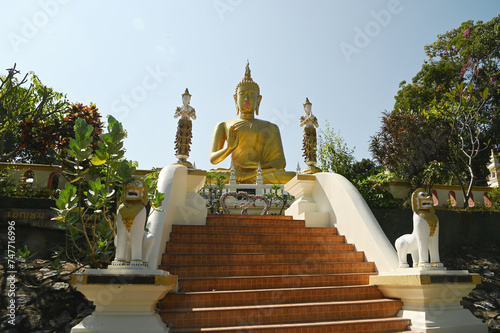 Phra Phut Tha Maha Phratimakhon It is a large golden Buddha image sitting outdoors on a hill. Inside Wat Phra That Doi Saket. This temple is another important one in the Northern part of Thailand.  photo
