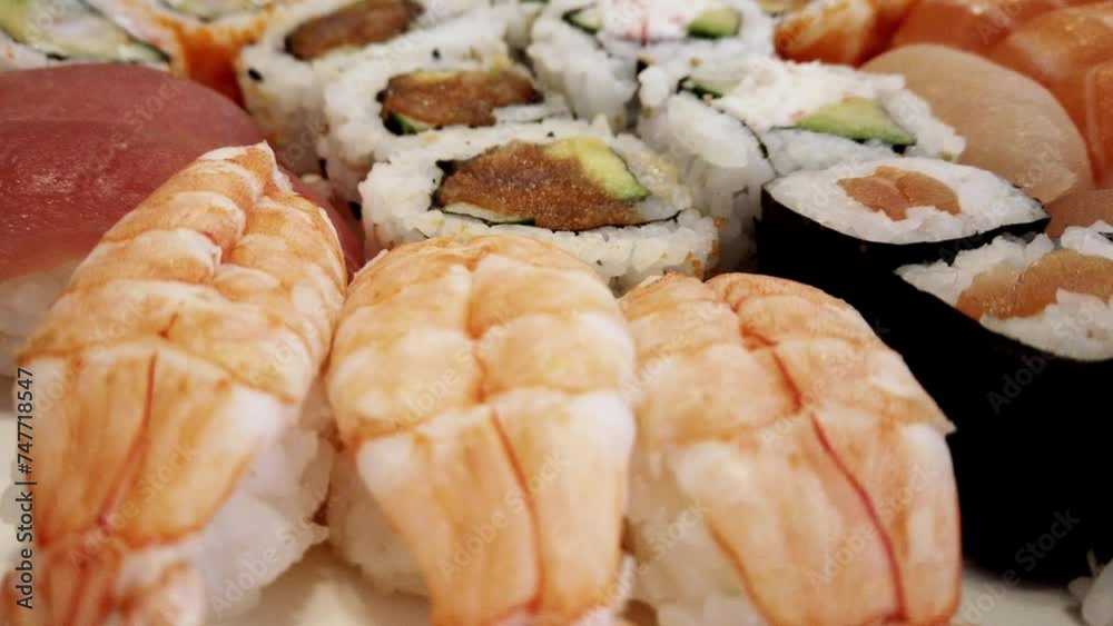 sushi variety arranged on a plate and rotating under a close-up camera view with colorful detailed pieces of sushi look beautiful and appetizing to reach out and eat them now sushi variety arranged on a plate and rotating under a close-up camera view with colorful detailed pieces of sushi look beautiful and appetizing to reach out and eat them now