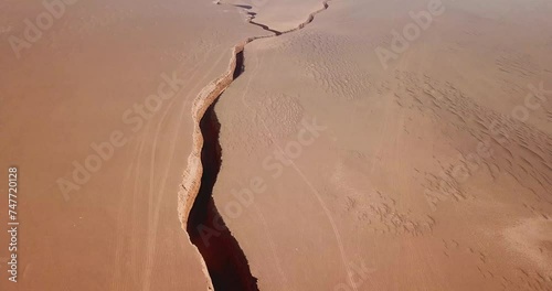 sky line in horizon desert scenic wonderful landscape the geological twin fault on Earth snake tongue  shape canyon deep dark valley crack ground in iran lut natural off road adventure Arabian culture  photo