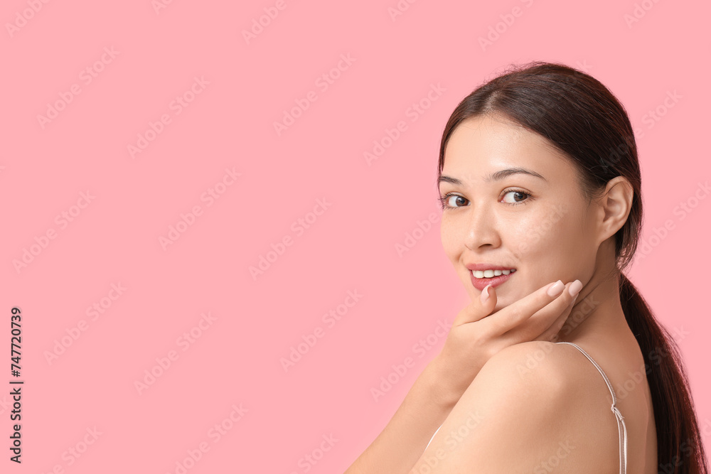 Beautiful young Asian woman on pink background Beautiful young Asian woman on pink background