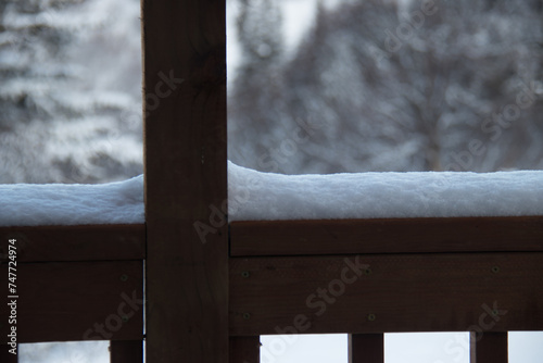 snow on a wooden railing