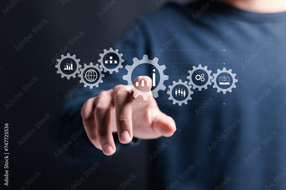 Business analytics and big data analysis concept. Process automation management with KPI financial charts and graph, marketing dashboard. Businessman touching analysis icon on virtual screen.