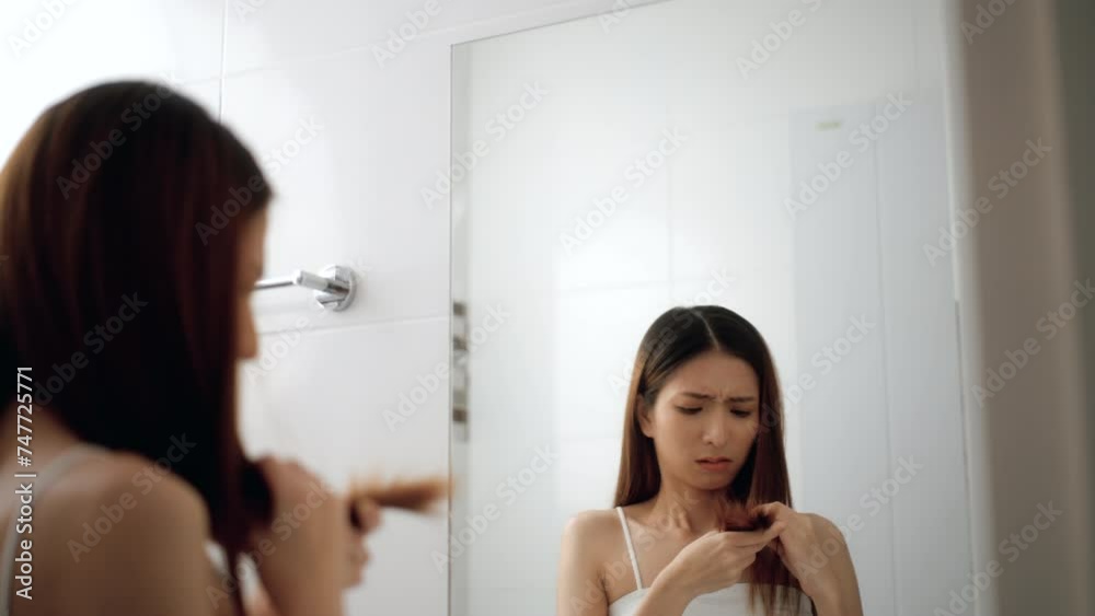 Worry moment of Attractive asian women have unhealthy hair problems from hair coloring looking at mirror in bathroom. Unhappy Young pretty female sad her hair dry, loss. Worry moment of Attractive asian women have unhealthy hair problems from hair coloring looking at mirror in bathroom. Unhappy Young pretty female sad her hair dry, loss.