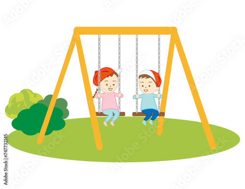 公園でブランコで遊ぶ小さな女の子達