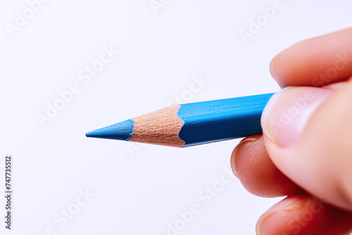 Hand holding a blue pencil, business economy financial concept