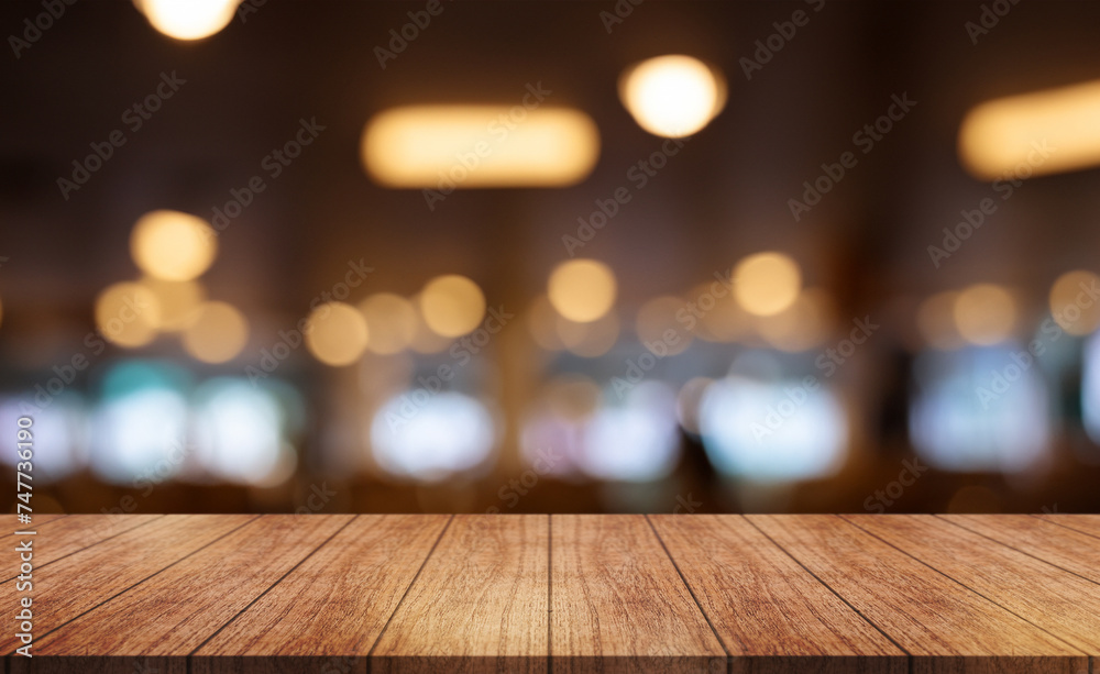 Empty wooden table top with lights bokeh on blur restaurant background.