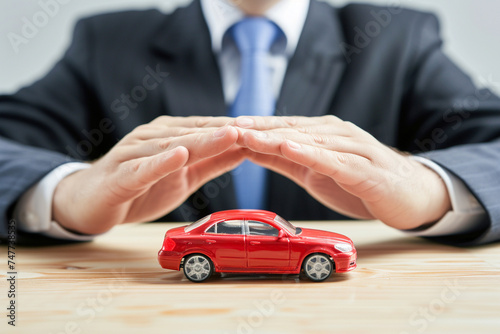 businessman with car model car insurance symbol bokeh style background