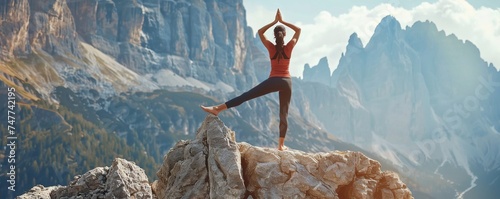 fitness girl practicing yoga on mountai photo