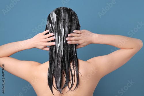 Asian woman applying hair m...