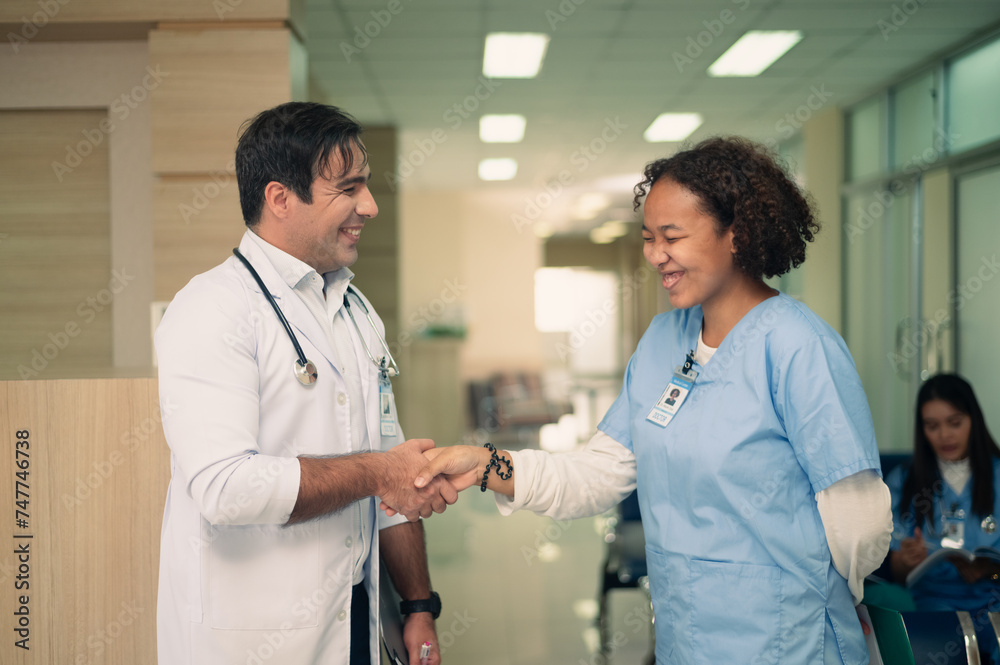 American doctor working in hospital, Team doctor discussion report on folder medicine, profession and healthcare concept American doctor working in hospital, Team doctor discussion report on folder medicine, profession and healthcare concept