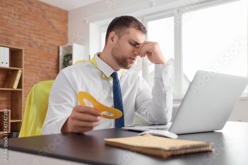 Tired young businessman wit...