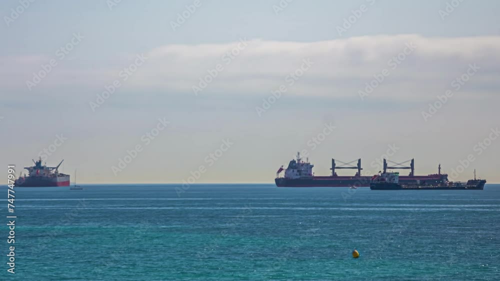 Huge industrial cargo ships on sea, small boats passing by, timelapse. Huge industrial cargo ships on sea, small boats passing by, timelapse.
