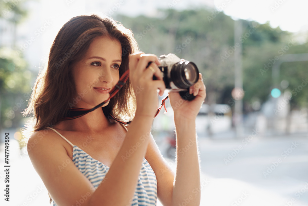 Happy woman, photography and city street with camera for photo, memory or capturing outdoor moment. Female person, tourist or photographer taking picture with lens for sightseeing in an urban town