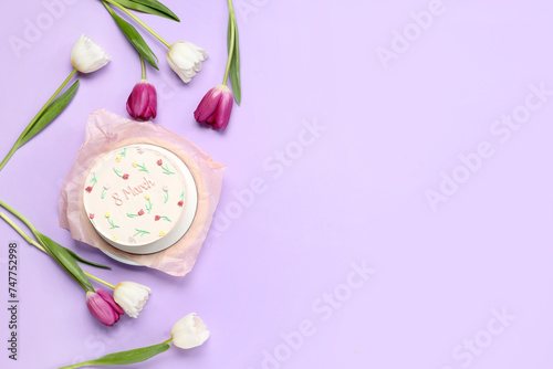 Sweet bento cake and beautiful tulips on lilac background. International Women's Day