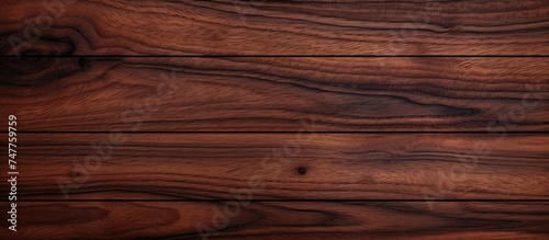 This detailed close up shows the natural texture and pattern of a dark wood surface. The seamless grain of the wood is visible, with intricate lines and knots creating a rich visual depth.