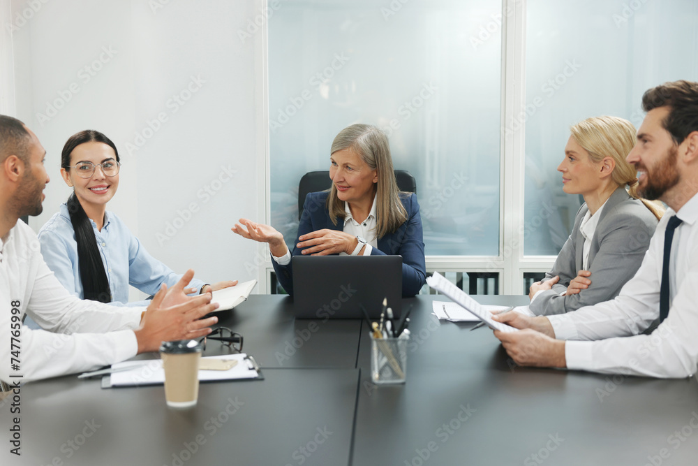 Lawyers working together at table in office Lawyers working together at table in office