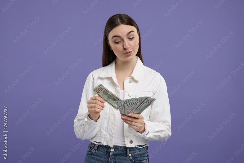 Woman with dollar banknotes on purple background Woman with dollar banknotes on purple background
